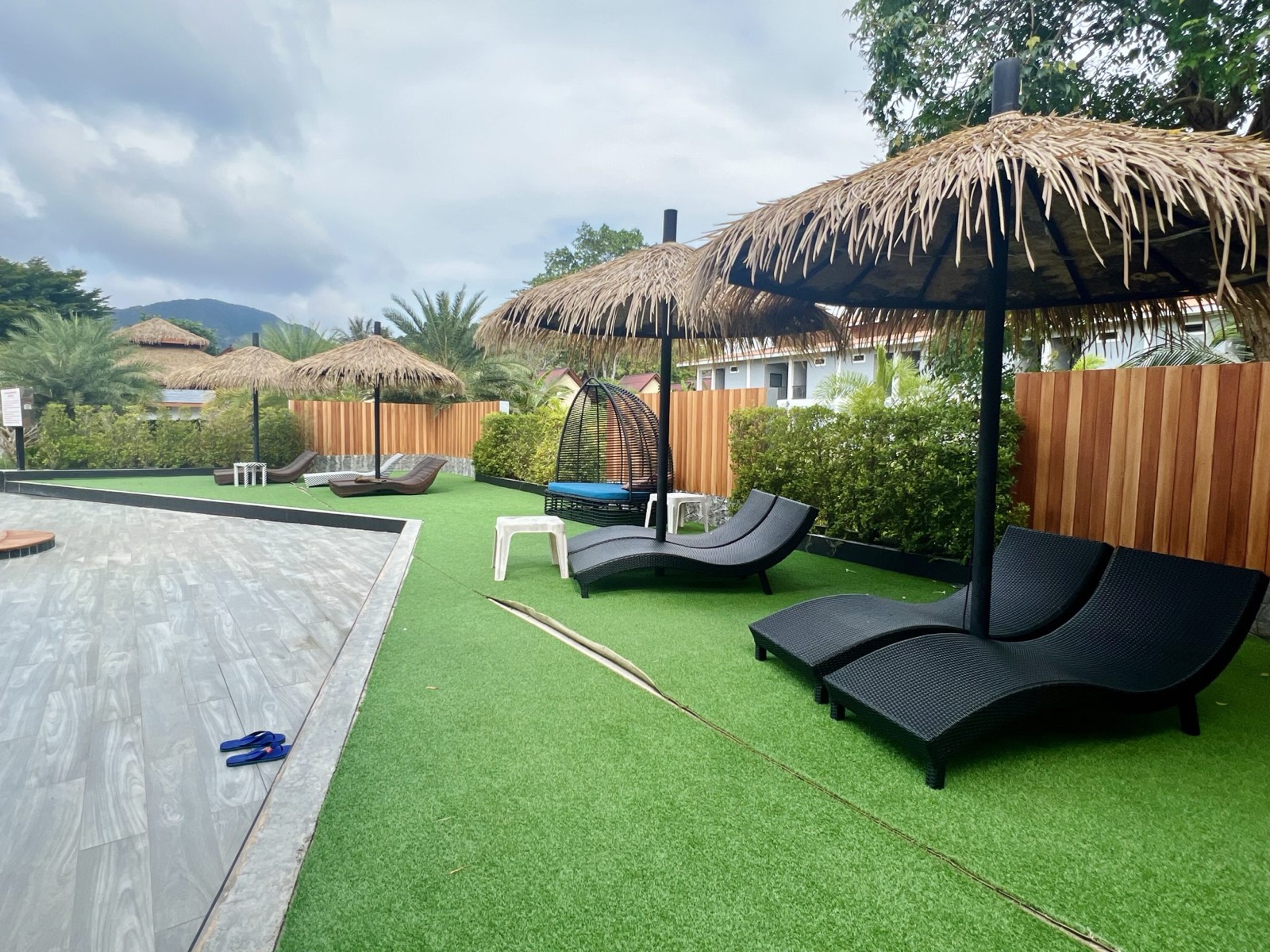 Freshly cleaned artificial turf around a pool area